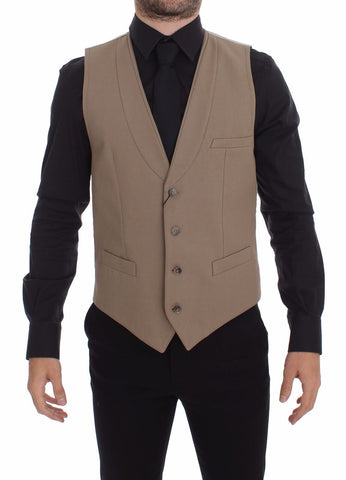Beige cotton slim fit button-front dress vest by Dolce & Gabbana, shown on a hanger with detailed stitching and smooth fabric.