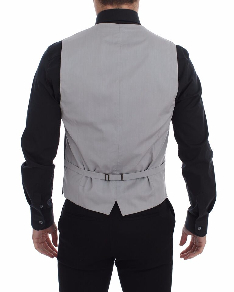 Gray cotton slim fit button-front dress vest by Dolce & Gabbana, shown on a mannequin with detailed stitching and classic design.