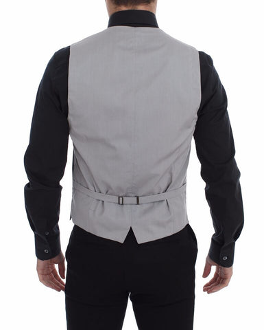 Gray cotton slim fit button-front dress vest by Dolce & Gabbana, shown on a mannequin with detailed stitching and classic design.