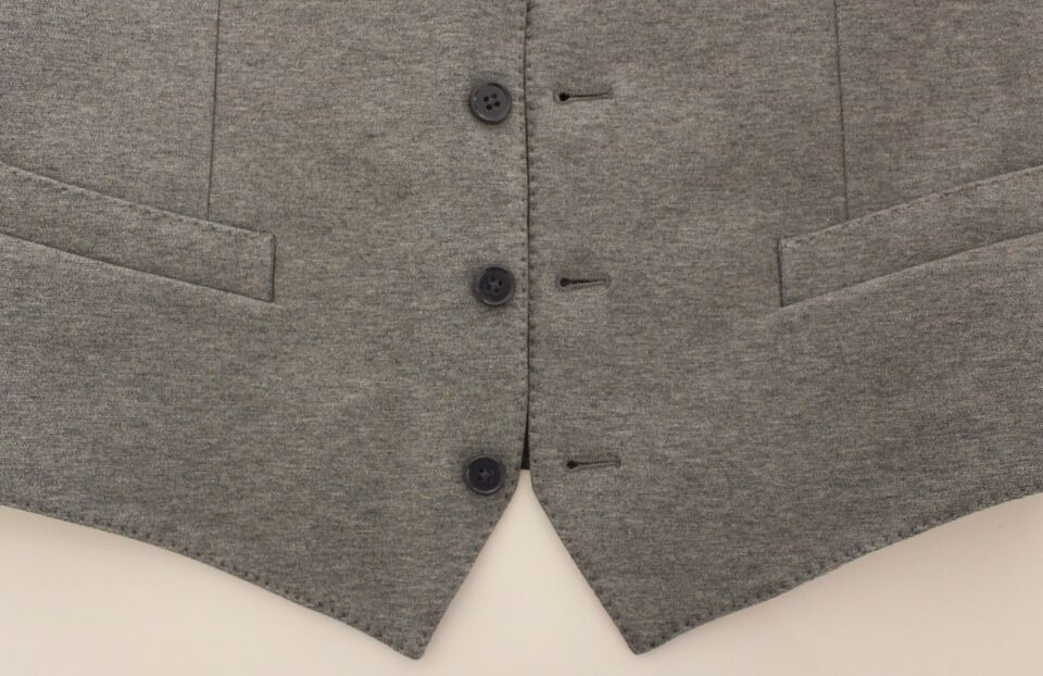 Gray cotton stretch dress vest blazer by Dolce & Gabbana, tailored fit with lapel collar and button closure, close-up view.