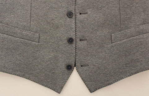 Gray cotton stretch dress vest blazer by Dolce & Gabbana, tailored fit with lapel collar and button closure, close-up view.