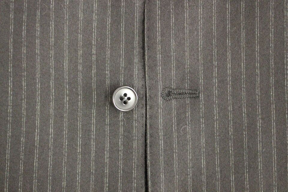 Black striped wool single-breasted vest by Dolce & Gabbana featuring tailored fit and classic lapel design.