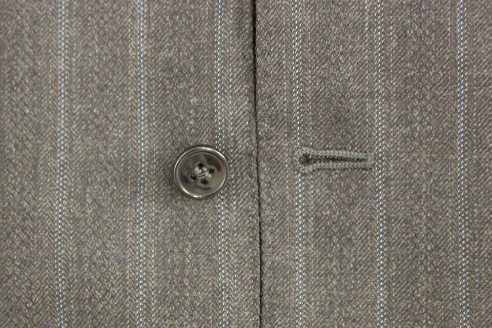 Gray wool vest with navy striped pattern and Dolce & Gabbana logo, sleeveless gilet style, front view.