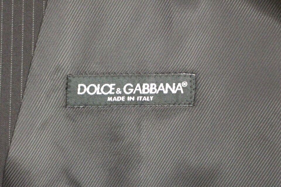Black striped wool single-breasted vest by Dolce & Gabbana, shown on a mannequin with tailored fit and classic lapel details.