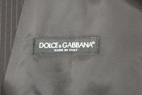 Black striped wool single-breasted vest by Dolce & Gabbana, shown on a mannequin with tailored fit and classic lapel details.
