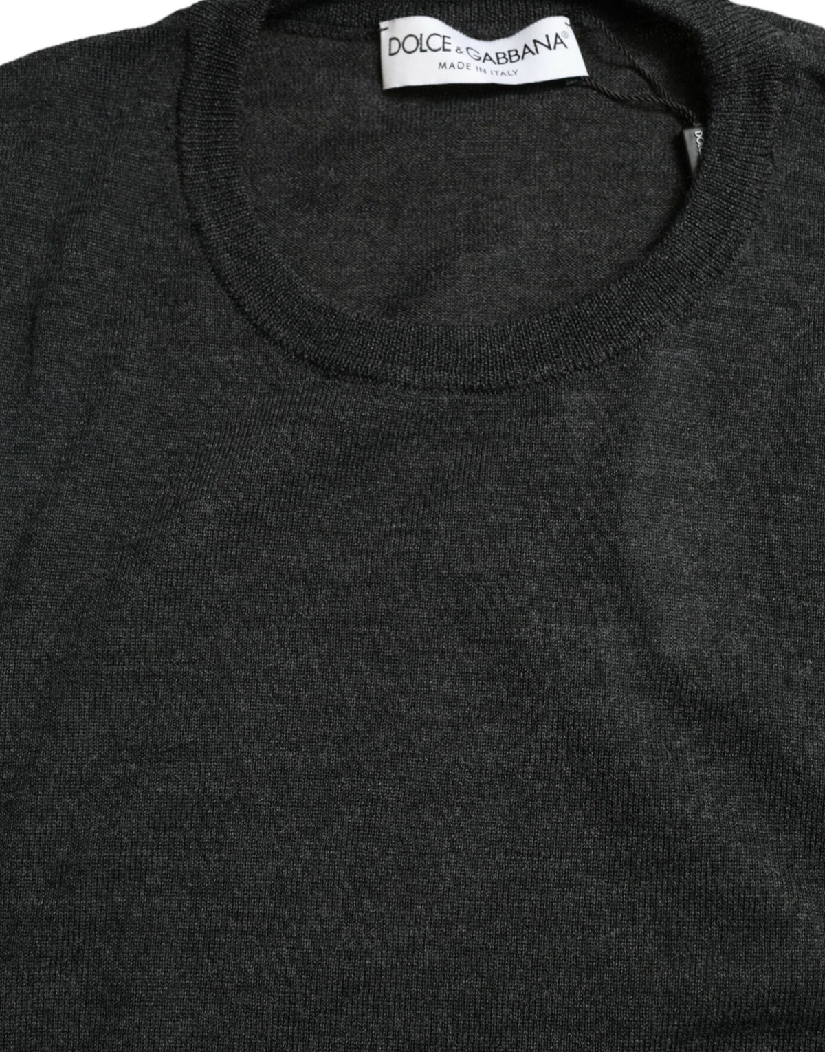 Gray wool round neck pullover sweater by Dolce & Gabbana, showing a close-up of the soft knit fabric and classic fit.