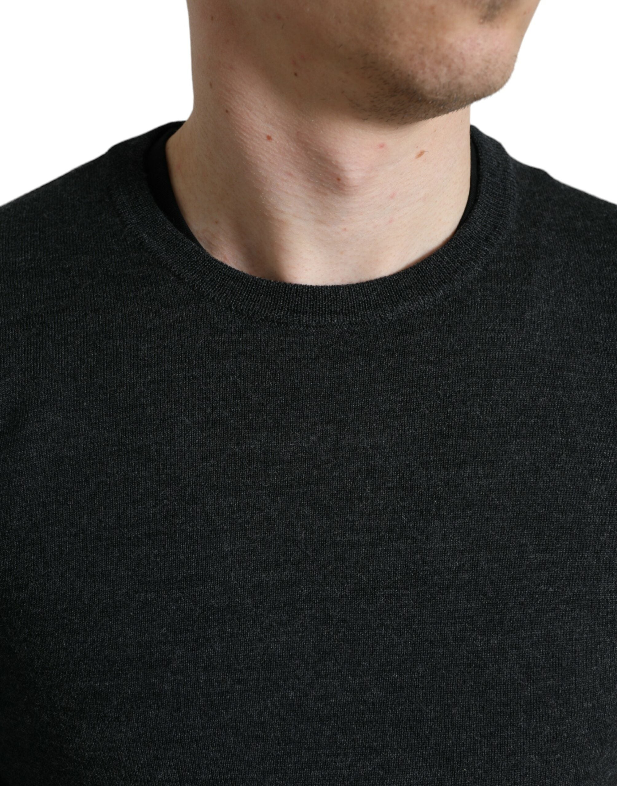 Gray wool round neck pullover sweater by Dolce & Gabbana displayed on a hanger.