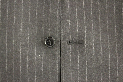 Gray striped wool Dolce & Gabbana logo vest gilet hanging on a wooden hanger, showcasing its textured fabric and stylish design.