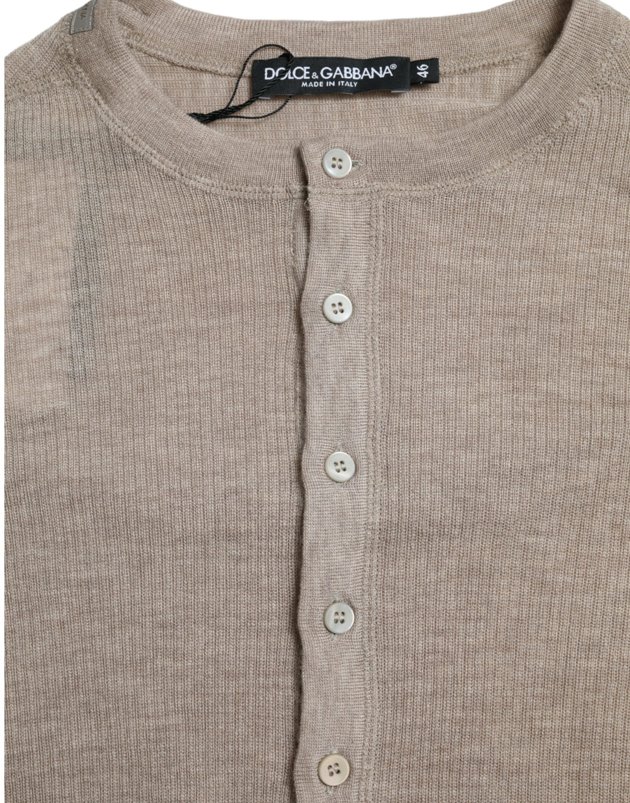 Beige cashmere Henley pullover sweater by Dolce & Gabbana displayed on a model. Soft, cozy knit with a buttoned neckline.