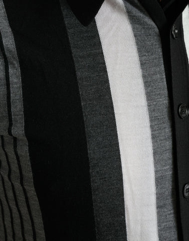 Black and white Dolce & Gabbana jumper cardigan polo sweater laid flat, showcasing its classic design and knit texture.