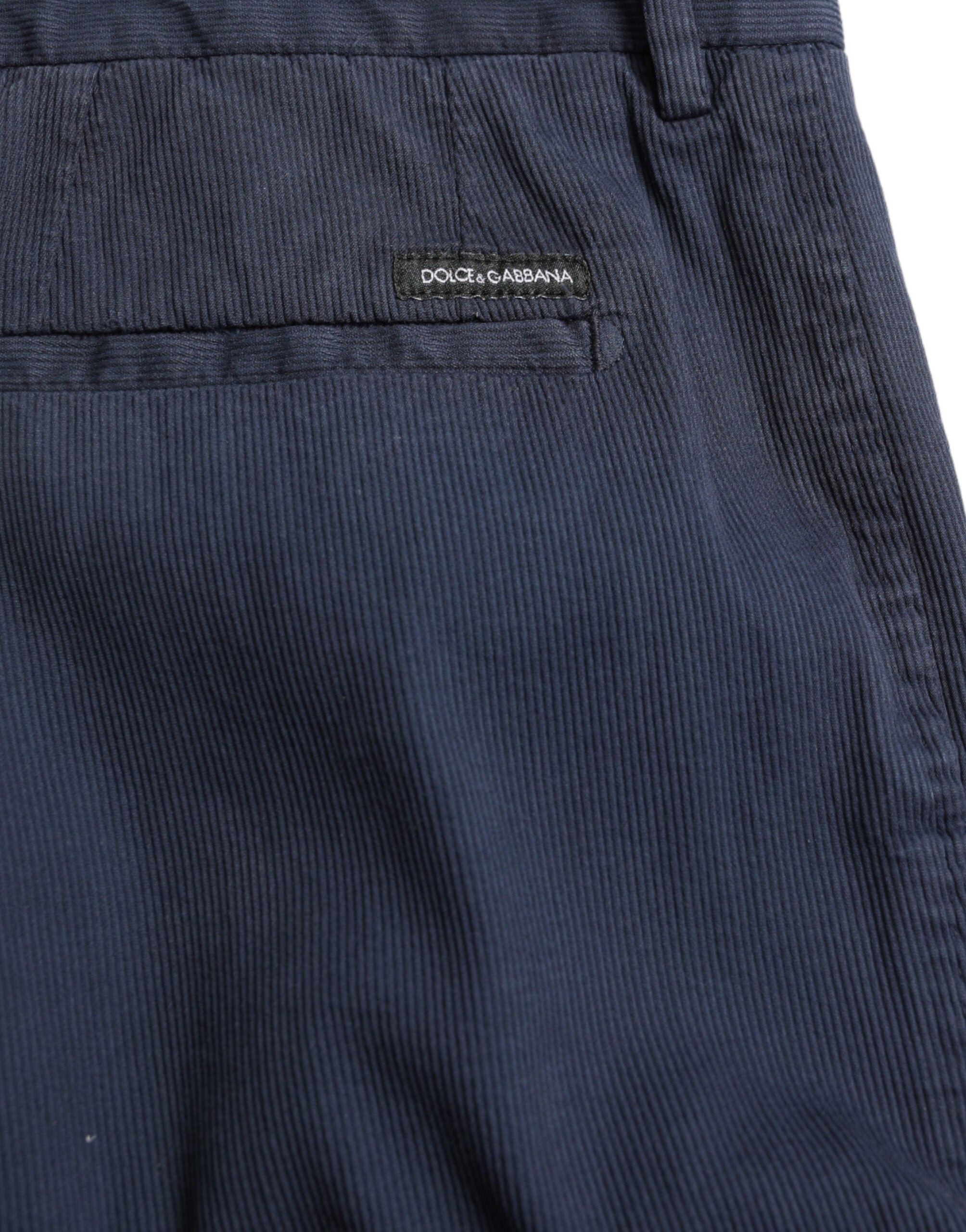 Dark blue cotton stretch slim fit dress pants by Dolce & Gabbana displayed on a hanger