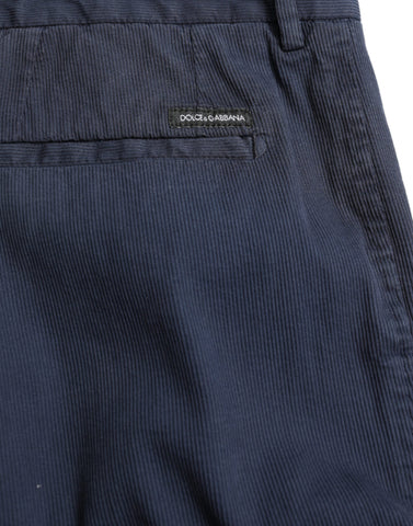 Dark blue cotton stretch slim fit dress pants by Dolce & Gabbana displayed on a hanger