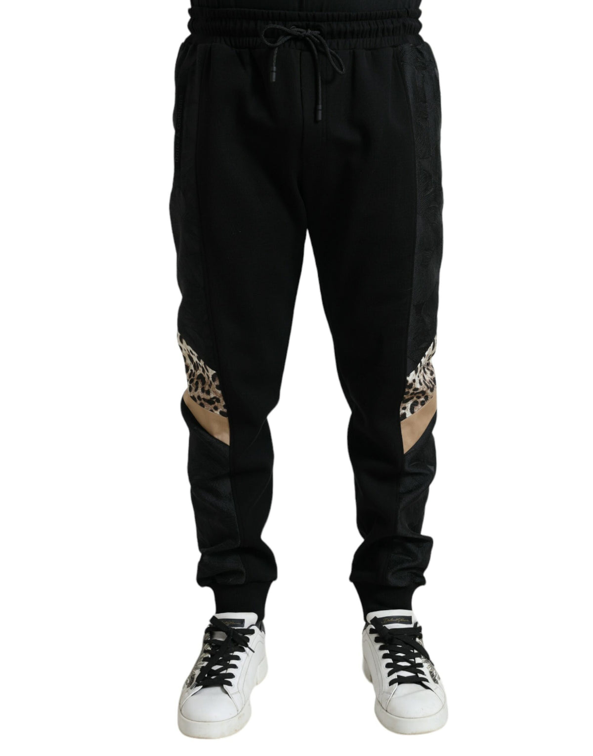 Black cotton slim stretch jogger pants by Dolce & Gabbana, showing a close-up of the fitted waistband and tapered leg design.