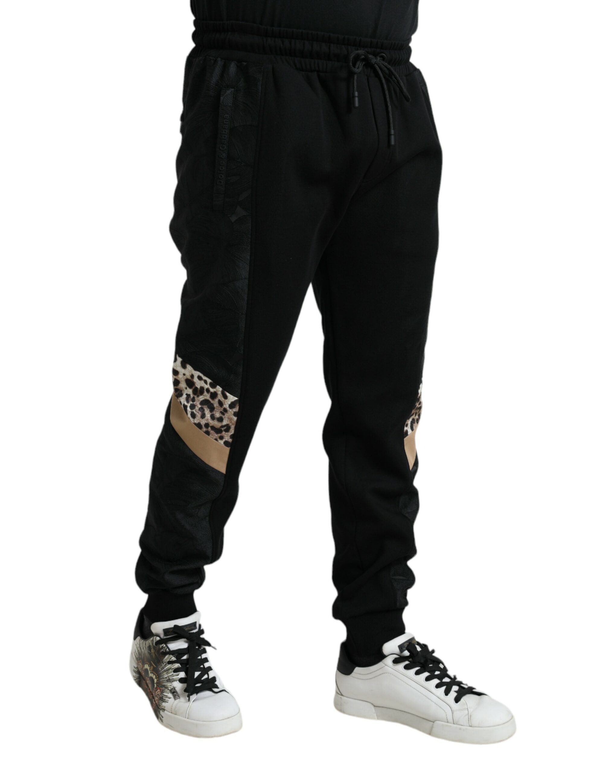 Black cotton slim stretch jogger pants by Dolce & Gabbana, showing the fitted design and elastic waistband.