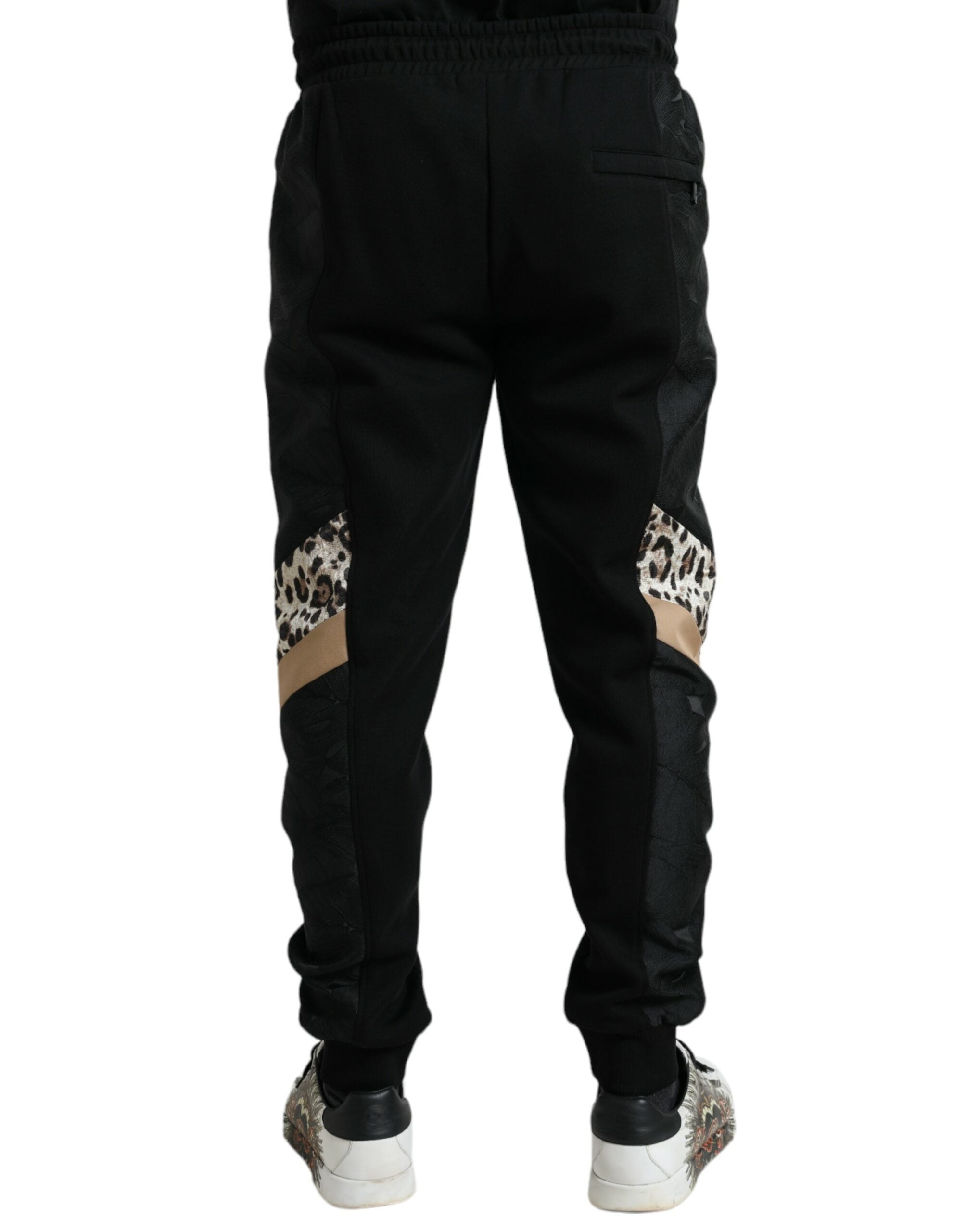 Black cotton slim stretch jogger pants by Dolce & Gabbana, featuring a tapered fit and casual athletic style.