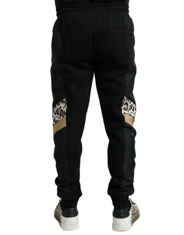 Black cotton slim stretch jogger pants by Dolce & Gabbana, featuring a tapered fit and casual athletic style.