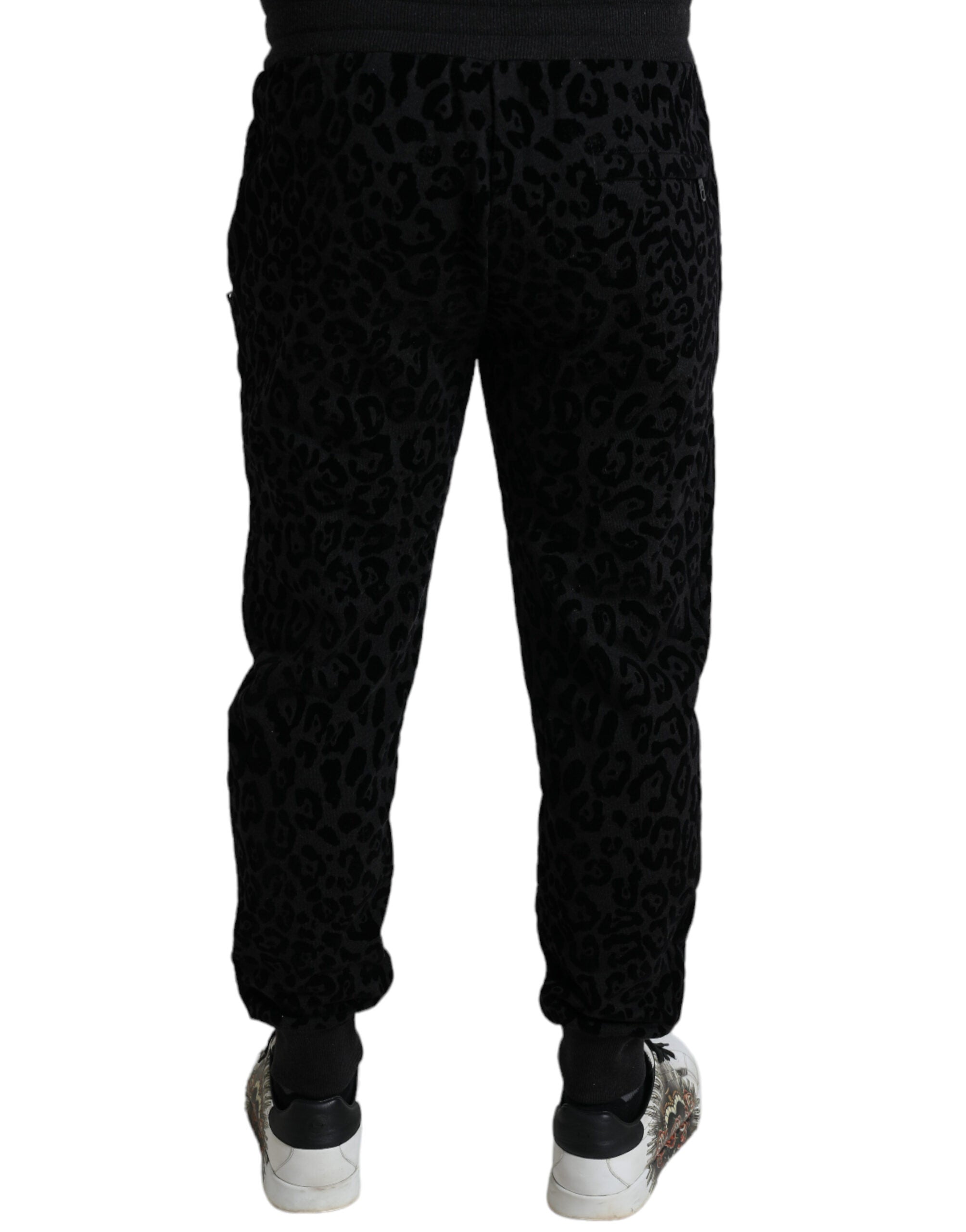 Black leopard print cotton slim fit jogger pants by Dolce & Gabbana, featuring a tapered design and elastic waistband.