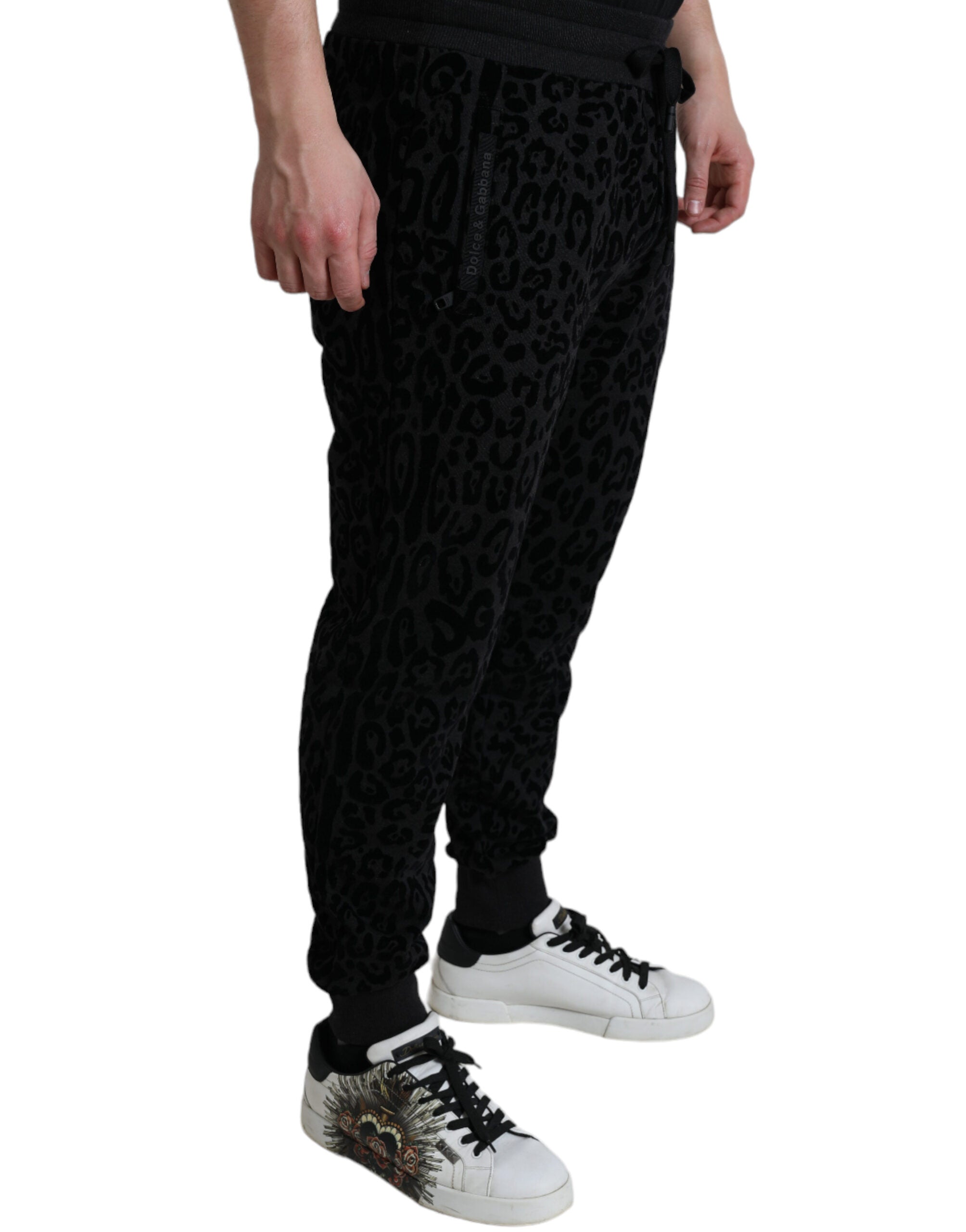 Black leopard print cotton slim fit jogger pants by Dolce & Gabbana, featuring a relaxed fit and stylish design.