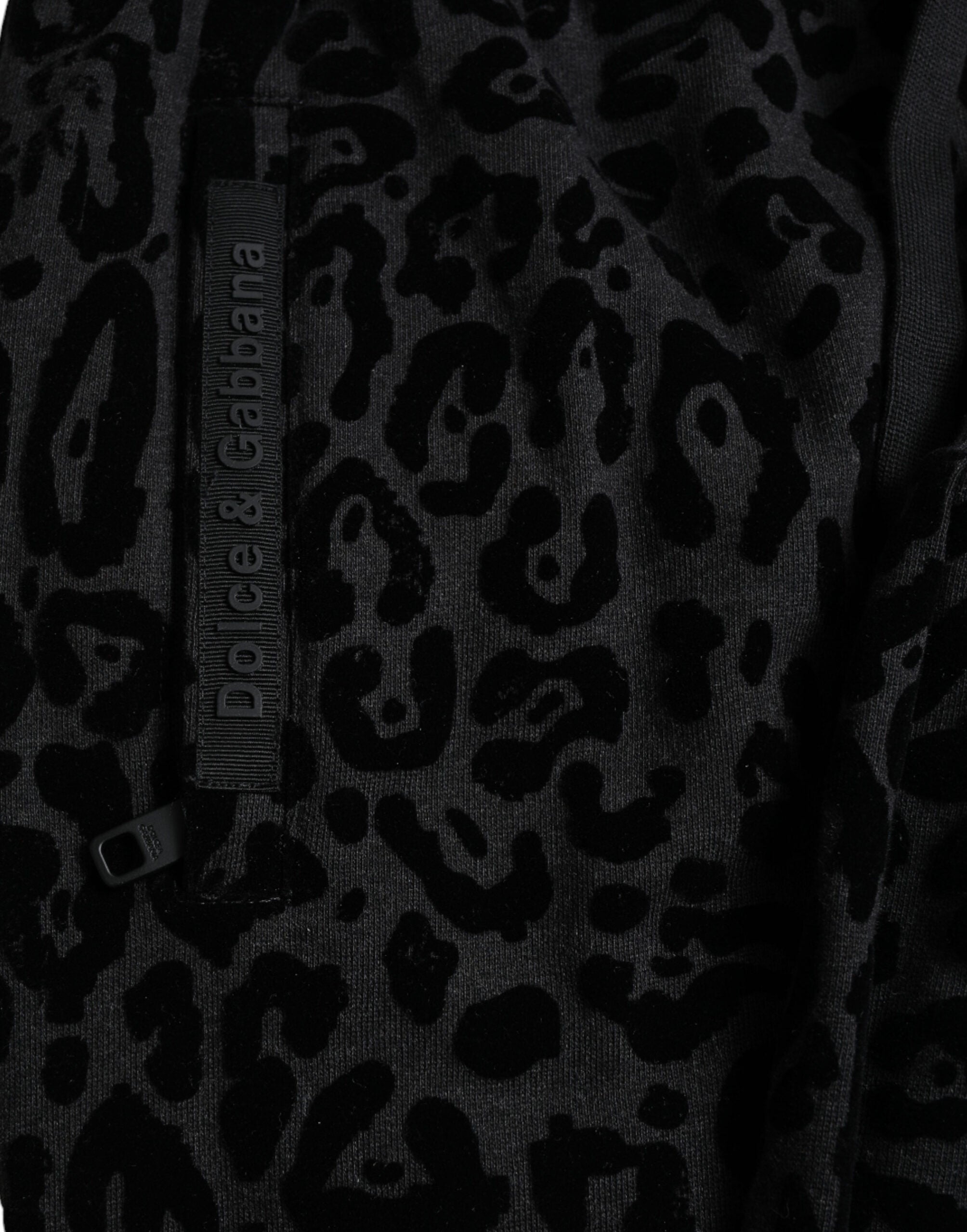 Black leopard print cotton slim fit jogger pants by Dolce & Gabbana, showing the stylish design and fit.