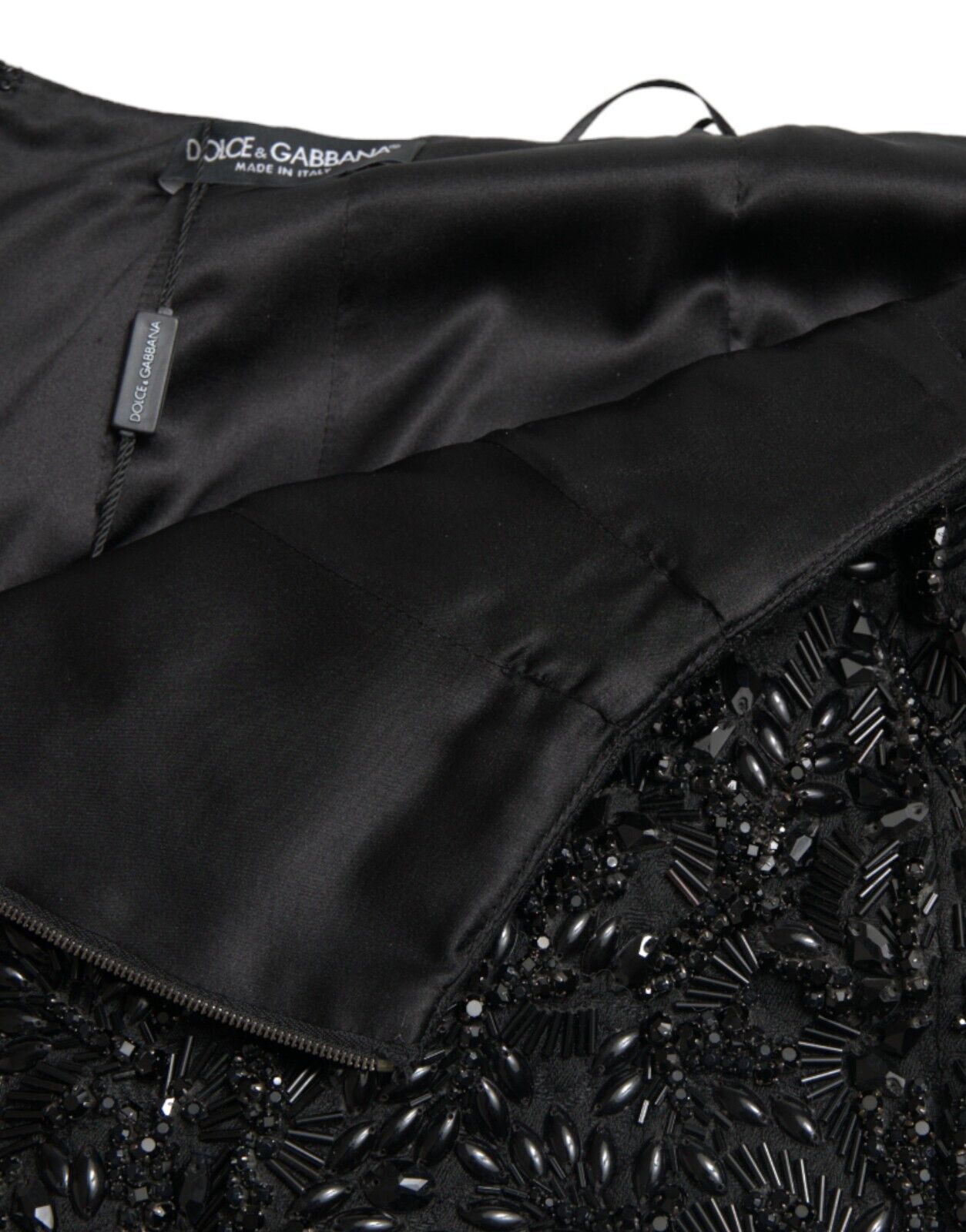 Black crystal-embellished handmade knee-length pencil skirt by Dolce & Gabbana, featuring a fitted silhouette and elegant design.