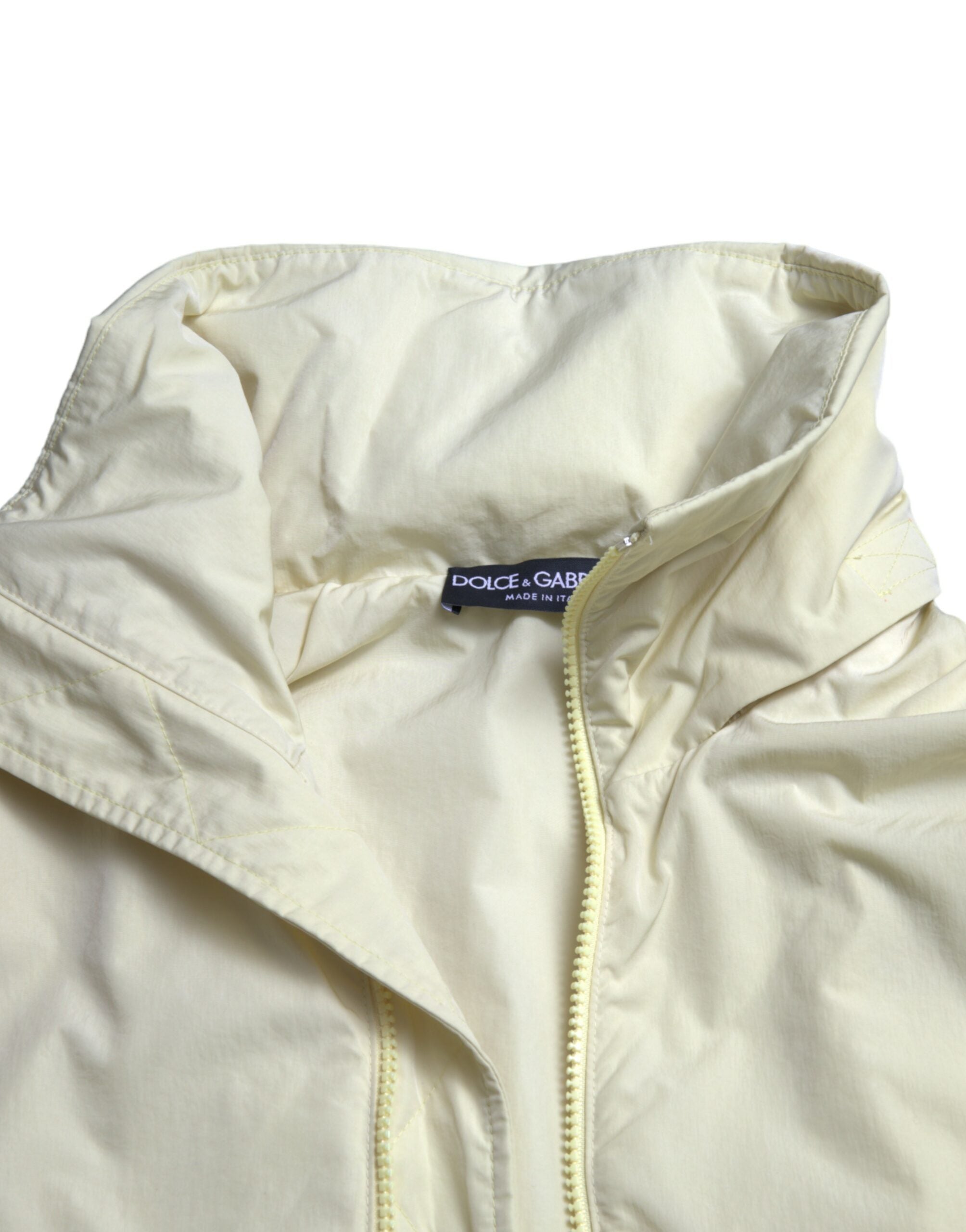 Yellow nylon collared full zip parka jacket by Dolce & Gabbana with front zipper and hood, shown on a plain background.