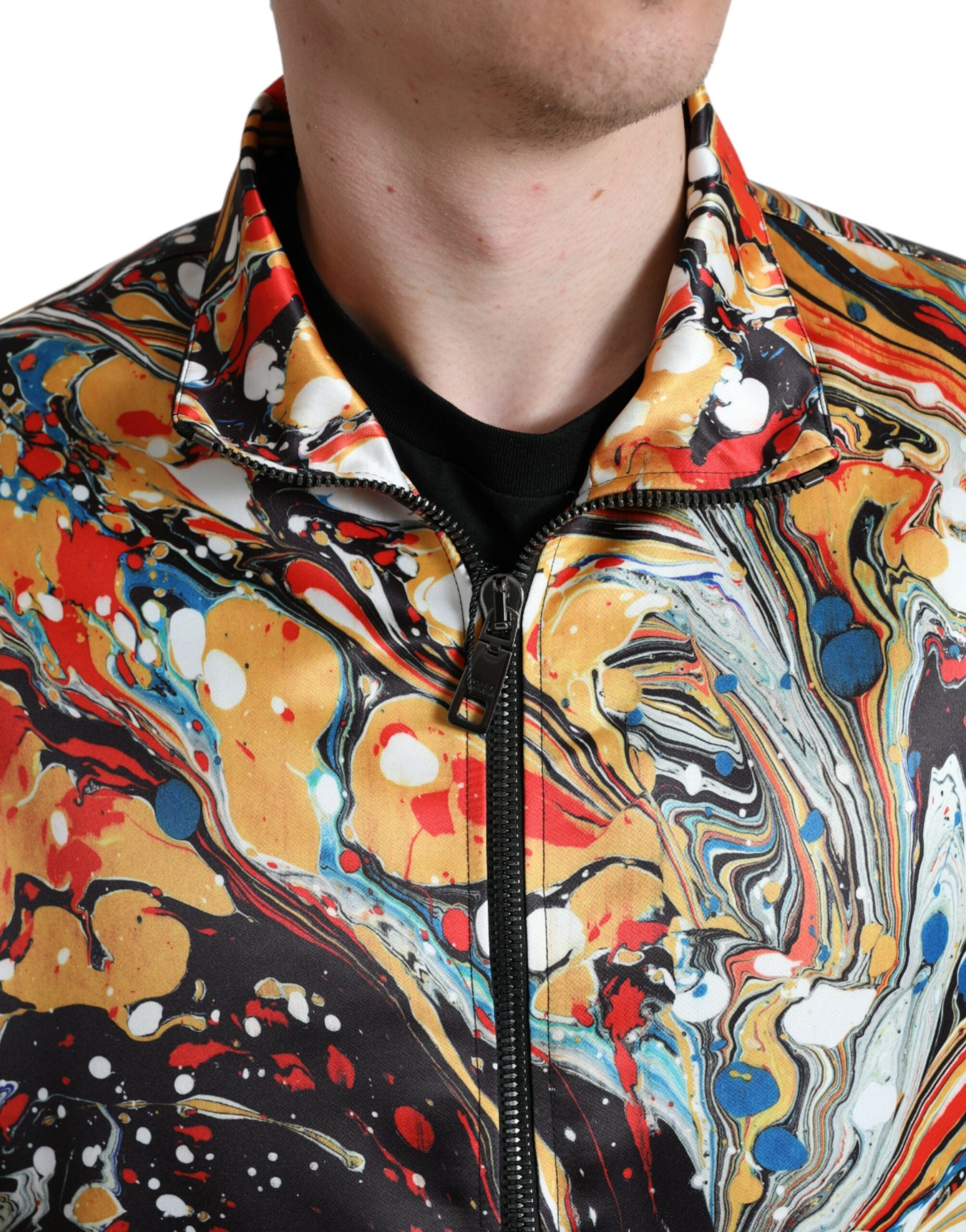 Multicolor abstract polyester bomber jacket by Dolce & Gabbana with vibrant print and ribbed cuffs, front zipper closure.