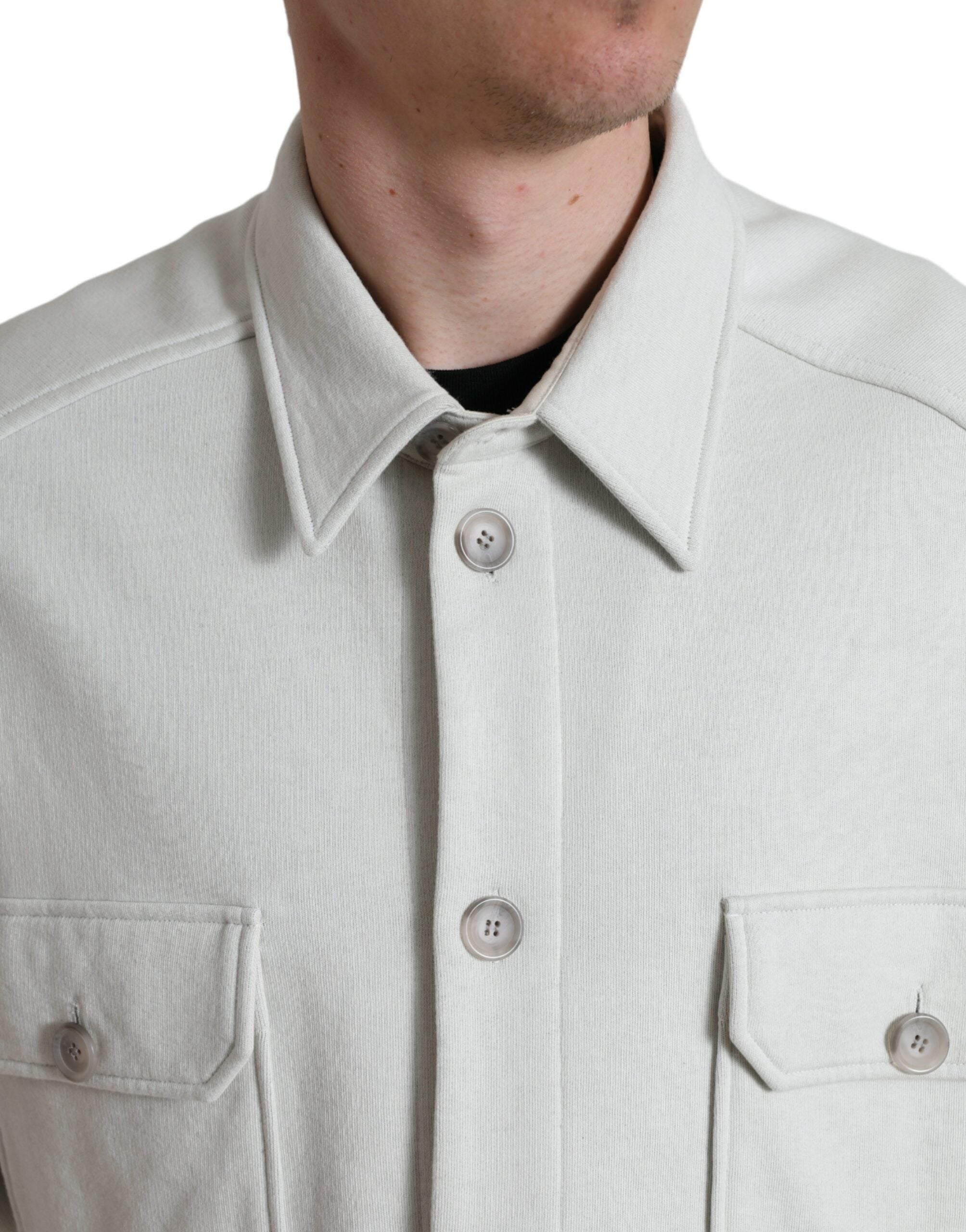 Grey cotton button-down collared coat jacket by Dolce & Gabbana, displayed on a hanger with visible button details.