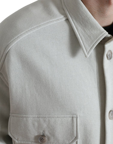 Grey cotton button-down coat jacket with a collared design from Dolce & Gabbana, shown hanging on a wooden hanger.