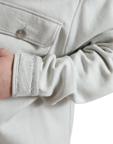 Grey cotton button-down collared coat jacket by Dolce & Gabbana, shown on a hanger with front view and detailed collar.