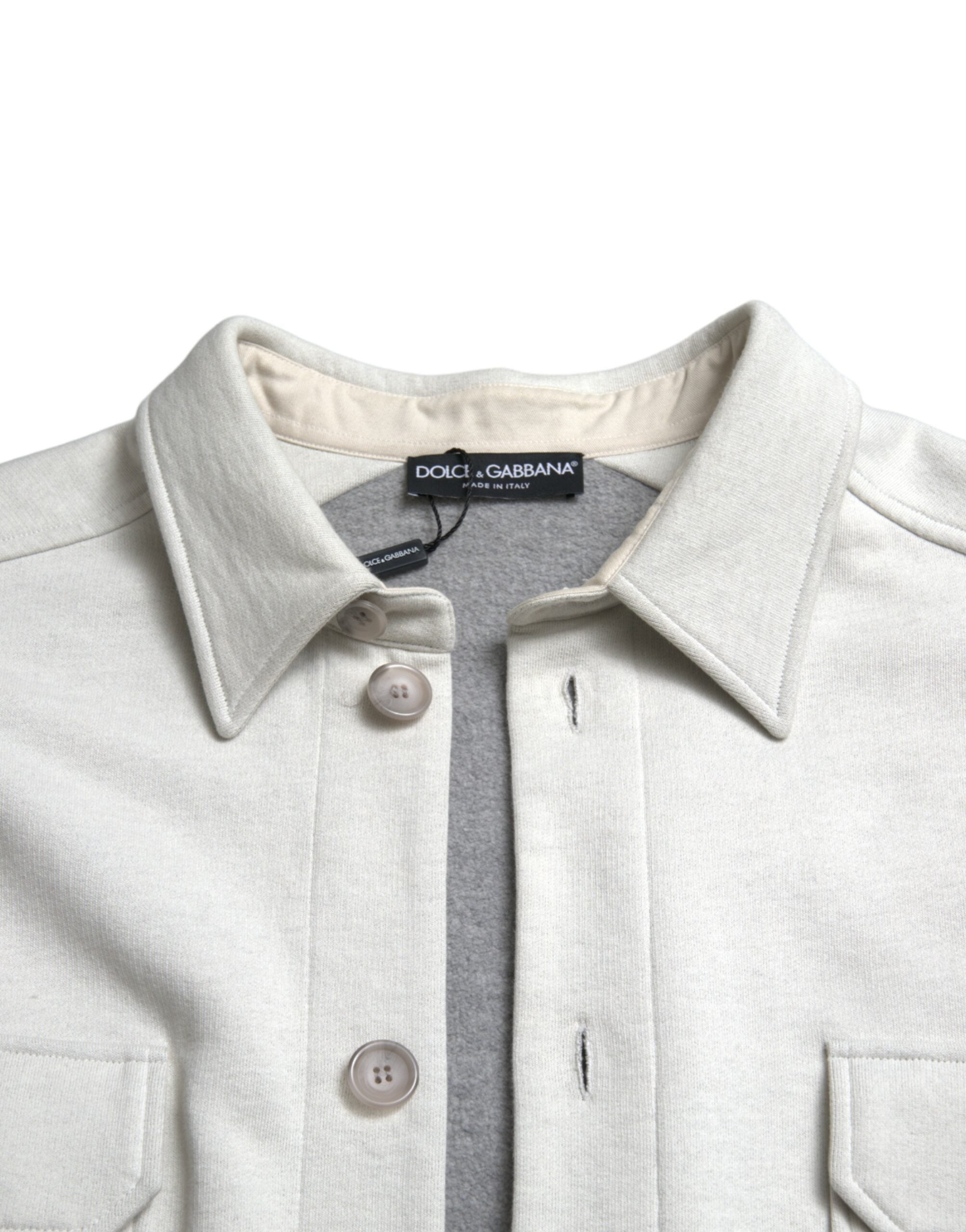 Grey cotton button-down collared coat jacket by Dolce & Gabbana, shown on a hanger with detailed fabric texture.