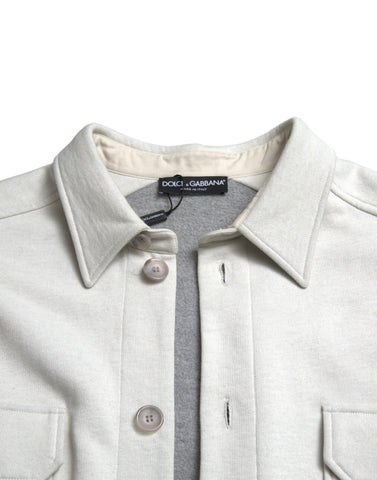 Grey cotton button-down collared coat jacket by Dolce & Gabbana, shown on a hanger with detailed fabric texture.