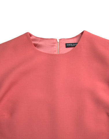 Pink Dolce & Gabbana virgin wool sleeveless mini dress displayed on a hanger with a simple background.