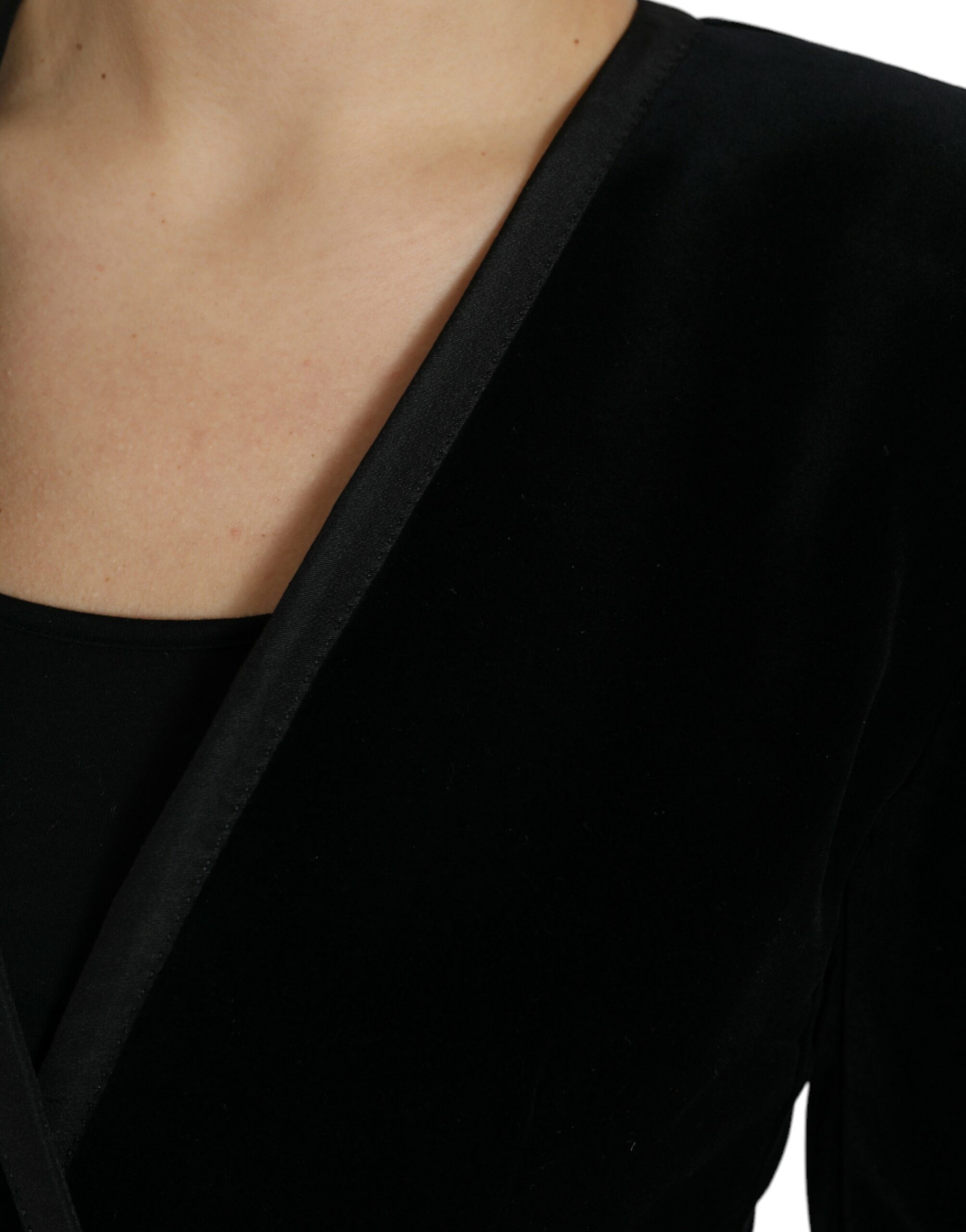 Black velvet cotton double-breasted jacket by Dolce & Gabbana, displayed on a hanger with detailed fabric texture.