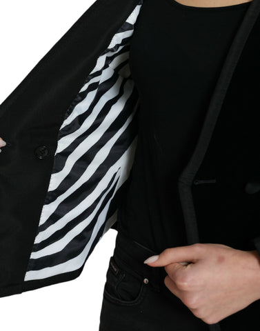 Black velvet cotton double-breasted jacket by Dolce & Gabbana, shown on a hanger with detailed fabric texture.