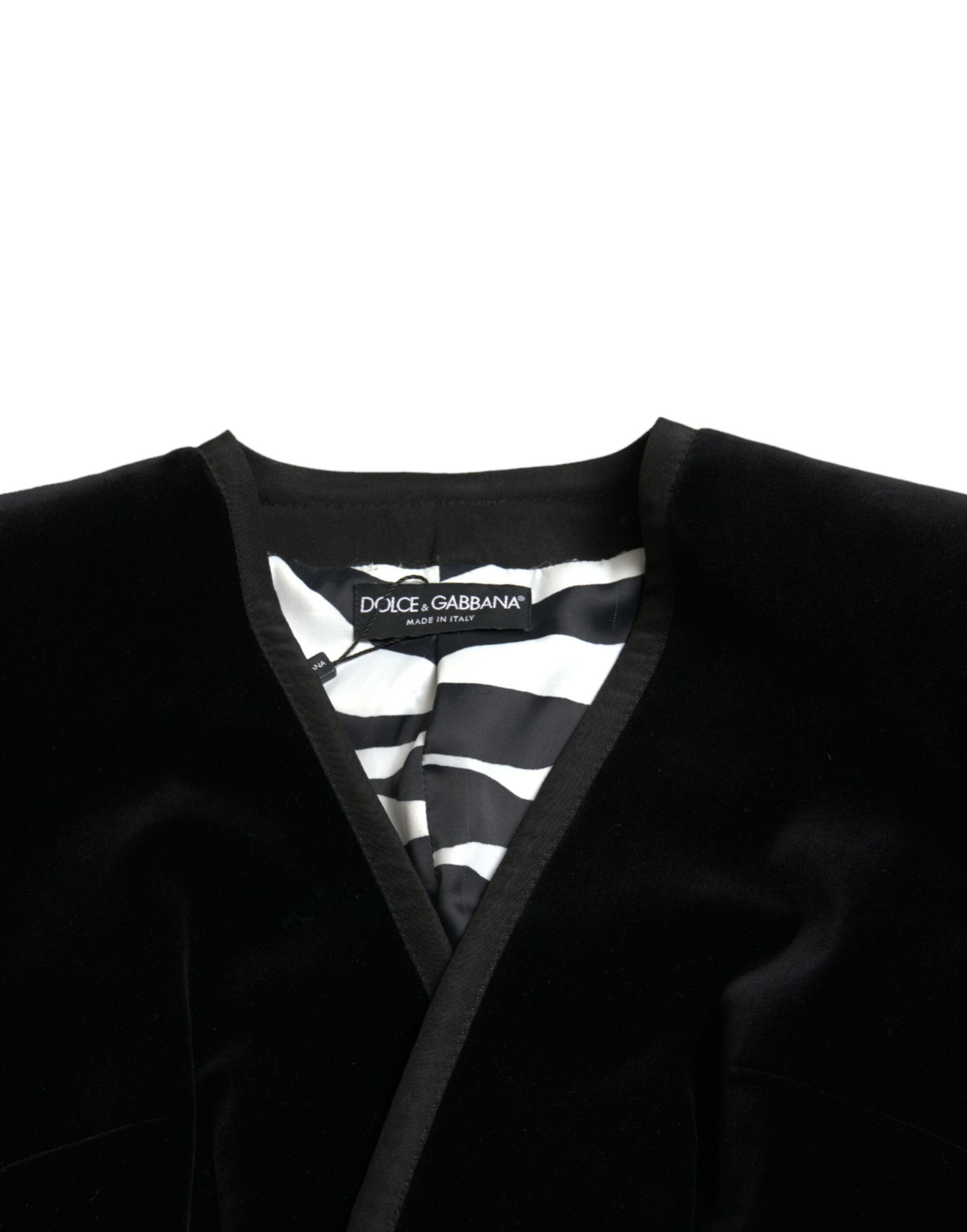 Black velvet cotton double-breasted jacket by Dolce & Gabbana hanging on a wooden hanger.