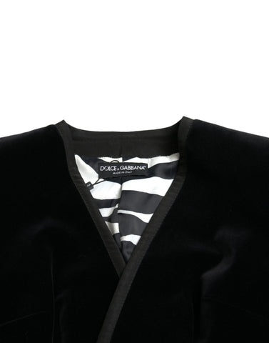 Black velvet cotton double-breasted jacket by Dolce & Gabbana hanging on a wooden hanger.