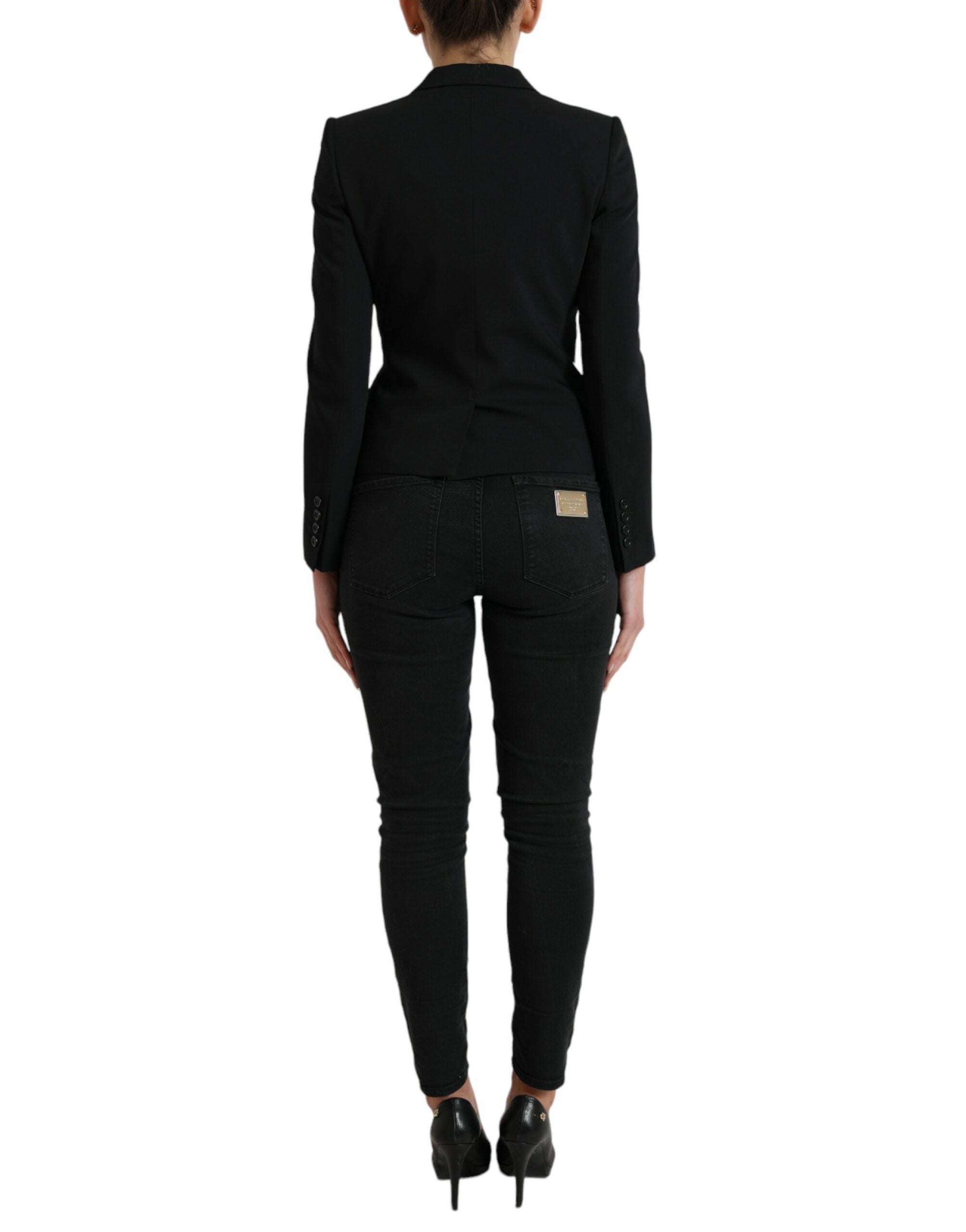 Black wool single-breasted blazer coat by Dolce & Gabbana, featuring classic lapels and tailored fit, shown on a hanger.
