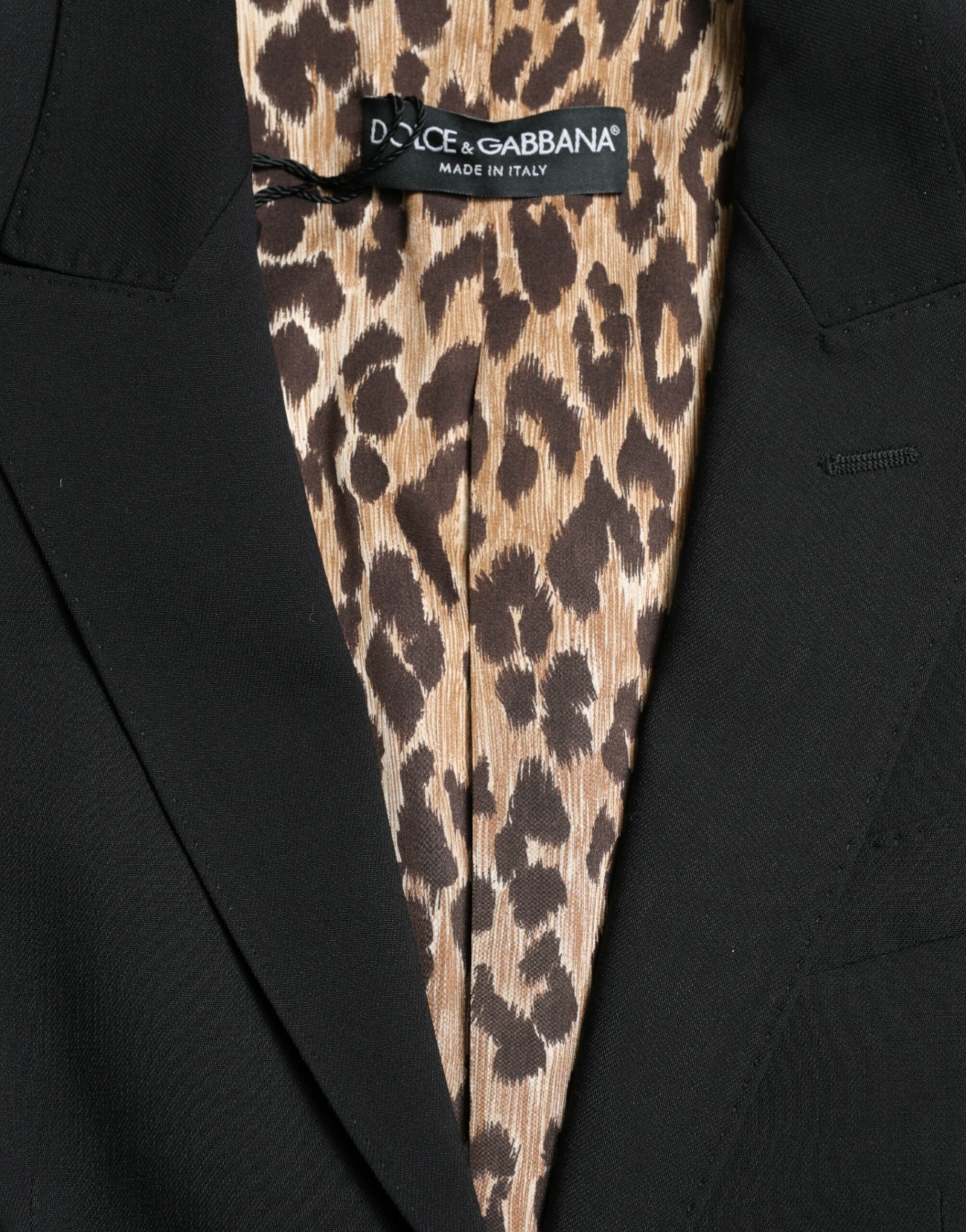 Black wool Dolce & Gabbana single-breasted blazer coat with notch lapels and tailored fit, displayed on a hanger.