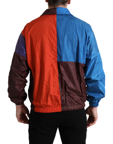 Multicolor Dolce & Gabbana windbreaker jacket with vibrant color blocks and lightweight design, shown hanging on a hanger.