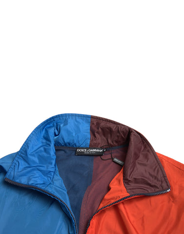 Multicolor Dolce & Gabbana windbreaker jacket with vibrant color blocks and lightweight fabric, shown on a model.