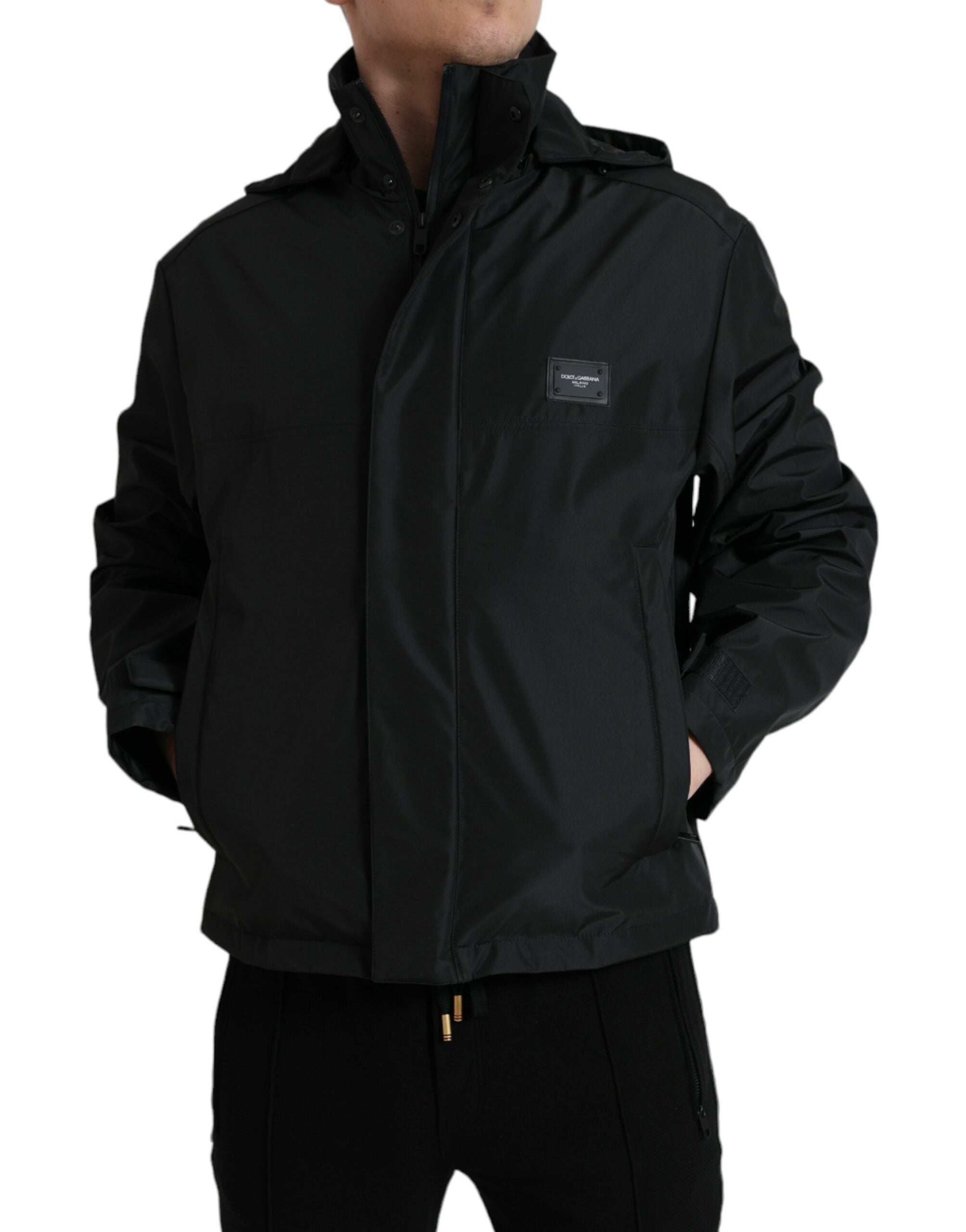 Black polyester hooded jacket with a logo plaque from Dolce & Gabbana, featuring a front zipper and casual fit.