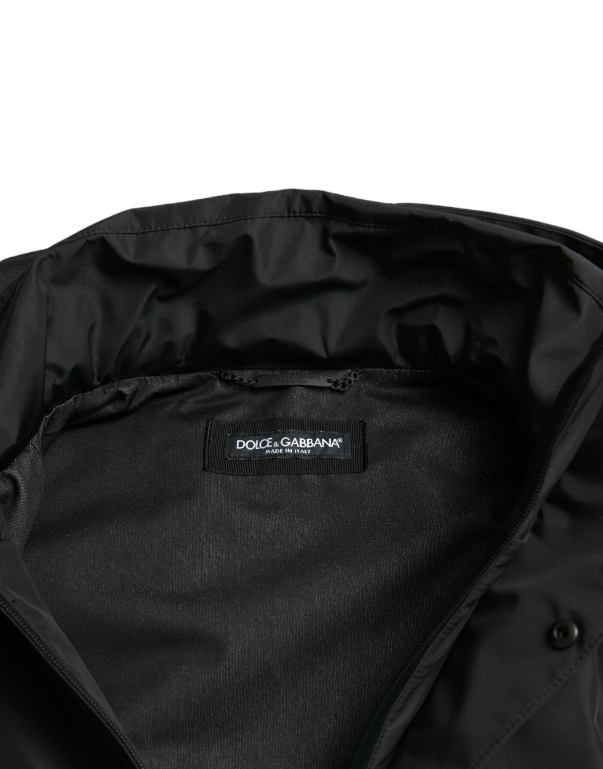 Black polyester hooded jacket with Dolce & Gabbana logo plaque, casual outerwear with front zipper and hood detail.