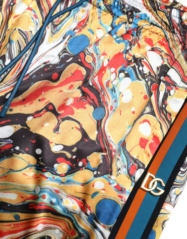 Multicolor marble print satin pants by Dolce & Gabbana featuring a luxurious, flowing fabric and vibrant pattern.