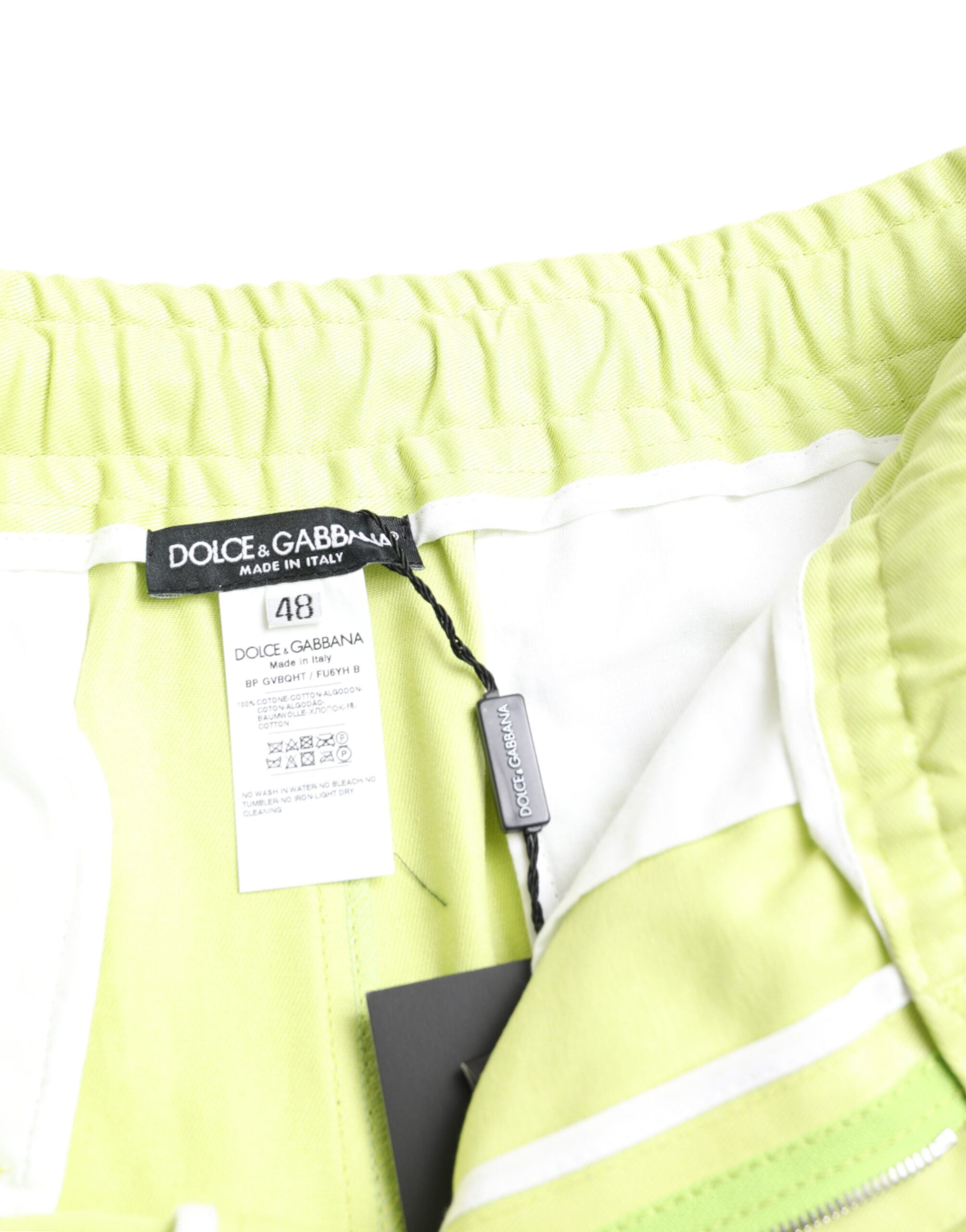 Light green cotton men's cargo Bermuda shorts by Dolce & Gabbana displayed on a model.