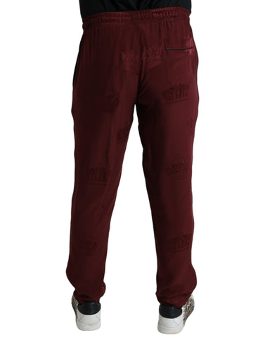 Maroon silk pajama pants with crown pattern by Dolce & Gabbana, featuring a relaxed fit and elegant design.