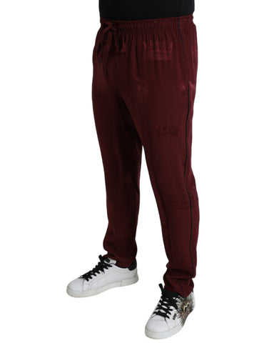 Maroon silk pajama pants with crown pattern by Dolce & Gabbana, featuring a relaxed fit and luxurious fabric.