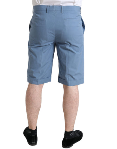 Sky blue cotton men's Bermuda shorts with folded hem by Dolce & Gabbana, shown folded neatly on a plain background.