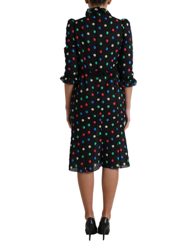 Black polka dot ruffle cotton midi dress by Dolce & Gabbana, featuring a feminine ruffled neckline and classic polka dot pattern.