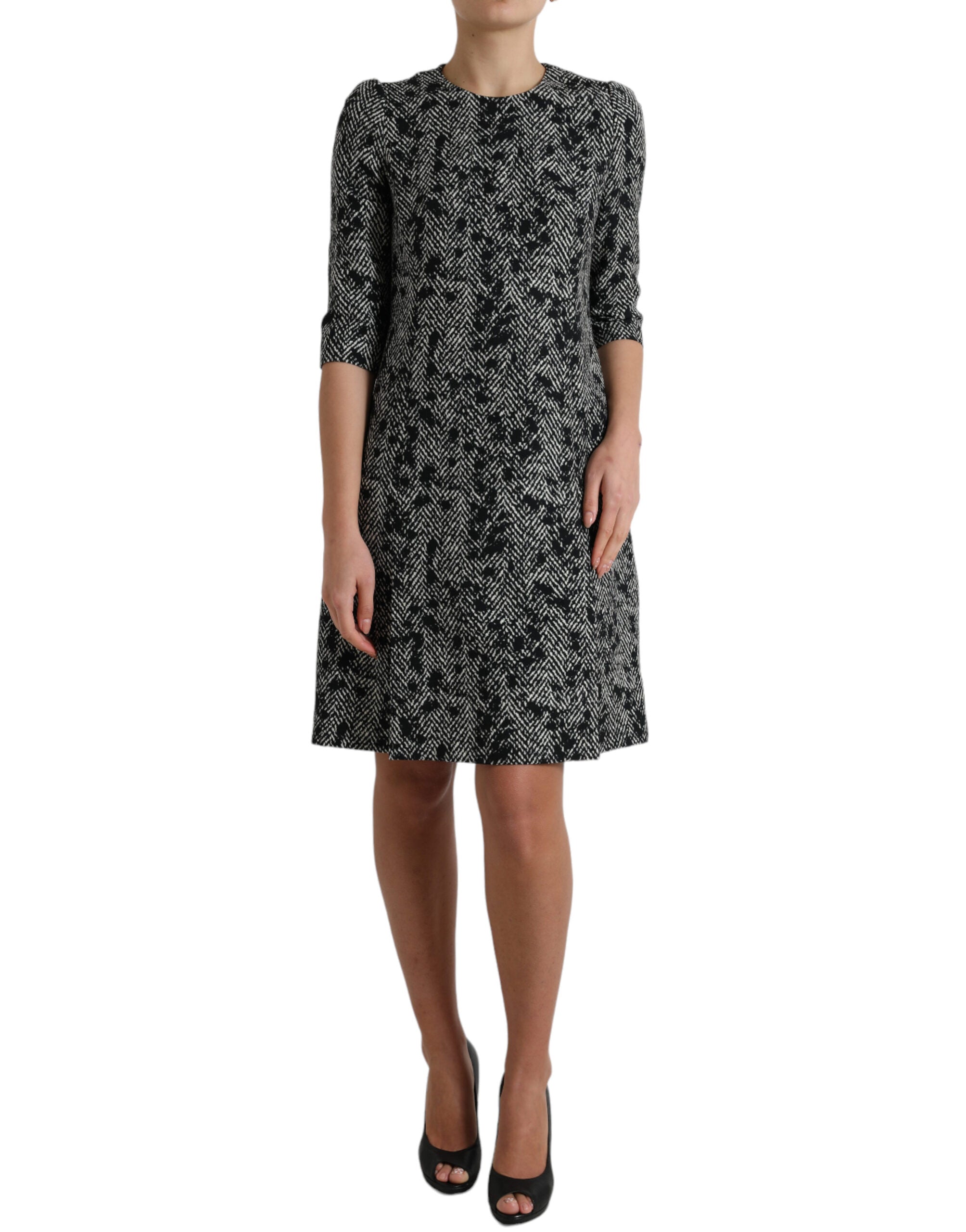 Black polyester shift mini dress with chevron pattern by Dolce & Gabbana, showcasing a sleek and stylish silhouette.