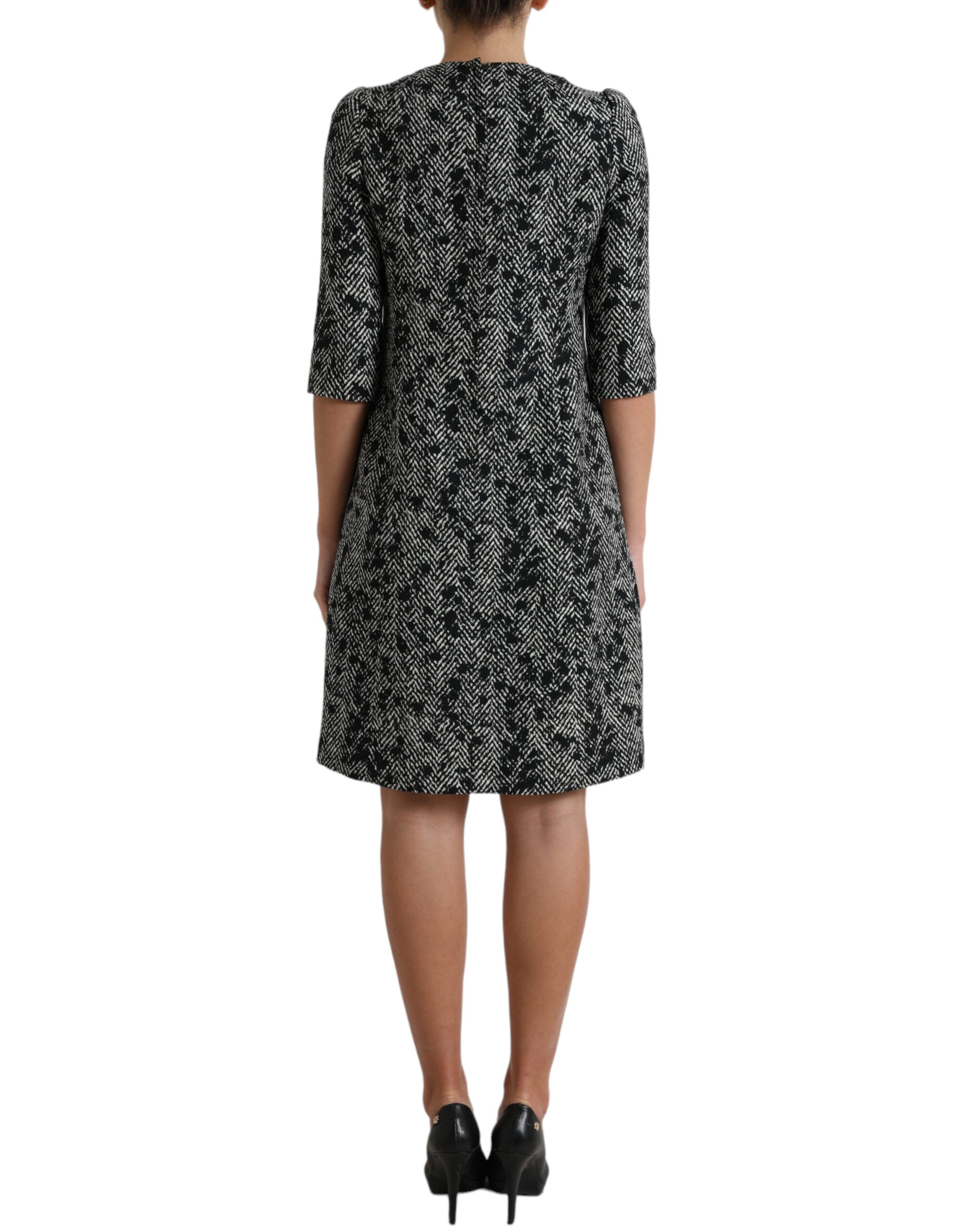 Black chevron polyester shift mini dress by Dolce & Gabbana, featuring a stylish fitted silhouette and bold geometric pattern.
